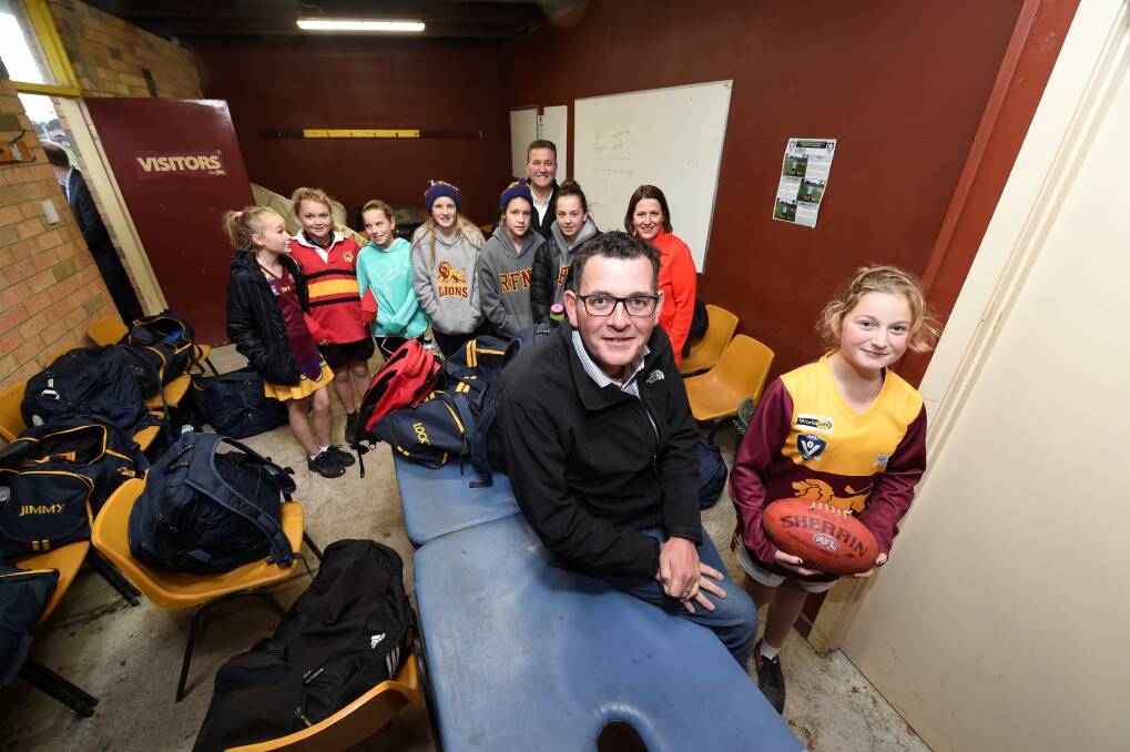 Play on: Victorian Premier Daniel Andrews and under-13 Redan Football and Netball Club footy team member Savannah Abson. Picture: Lachlan Bence