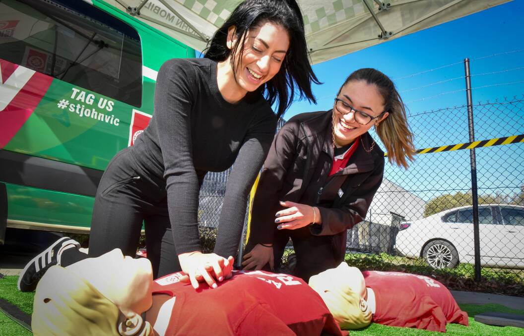 Teamwork: Adriana Saviane of St John Ambulance Australia and St John course presenter Rachel Schmidt practicing CPR on Saturday. Picture: Brendan McCarthy