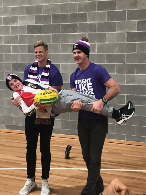 Given a boost: 12-year-old Blake Dridan gets up close with AFL heroes Nick Riewoldt and Jonathan Brown. Picture: Courtesy of the Dridan Family