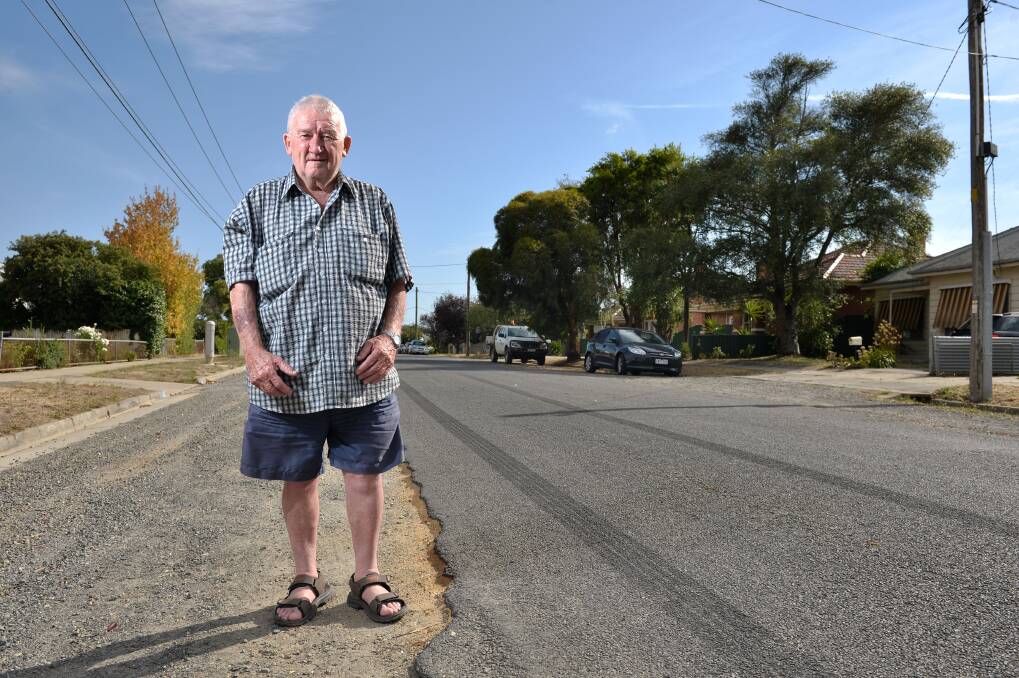 Frustrated: Barry Tuddenham stands in Spencer Street, where the bitumen is slowly chipping away. Picture: Adam Trafford