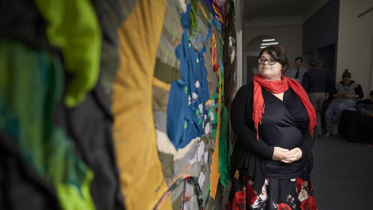 Stitched together: Architect and artist Tereasa Kenny stands with the textured tapestry 'The Journey' which she designed. Picture: Luka Kauzlaric