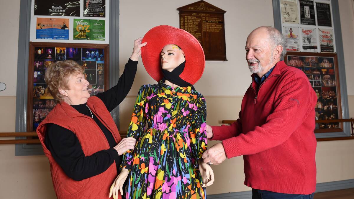 Snazzy: BLOC Music Theatre's Claire Thorpe and Peter Morey help a mannequin into her glad rags before a celebratory morning tea this Sunday. Picture: Kate Healy