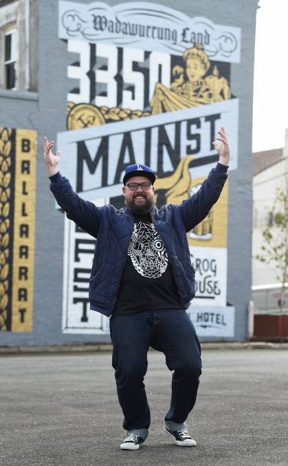 Writing is on the wall: Ballarat artist Travis Price stands in front of his handiwork, which was painted over three days with help from local creatives Jay Rankine and Karl Stehn. Picture: Lachlan Bence