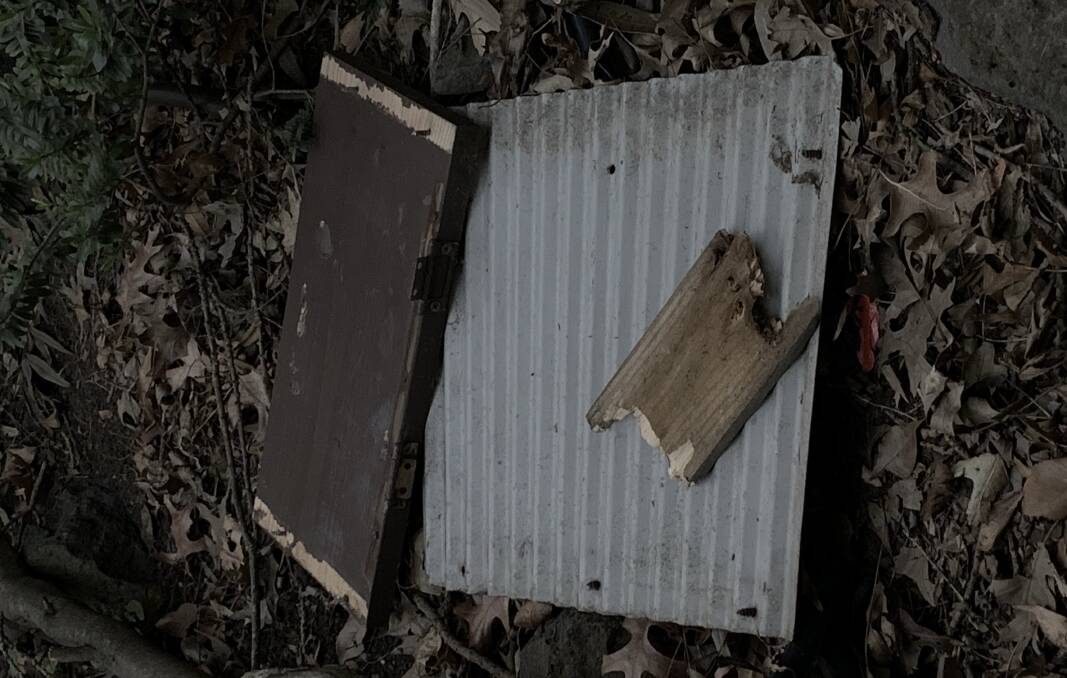Pieces of the letterbox remain on the ground near the property. 