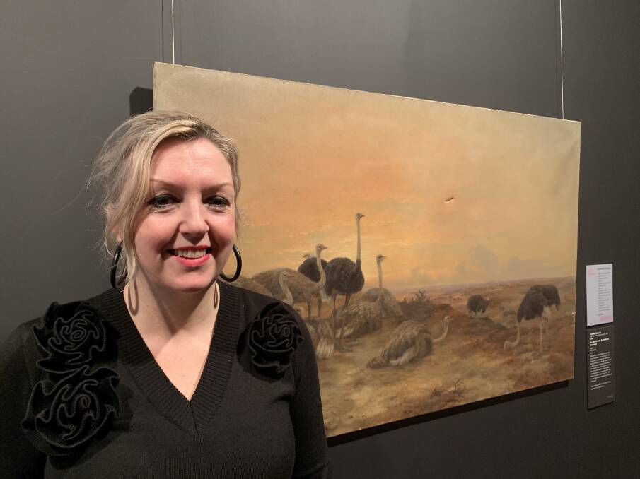 Ready and waiting: Art Gallery of Ballarat Louise Tegart in front of a painting by Charles Rolando, which has visible gouges in the canvas. The 'Adopt an Artwork' drive to restore a number of damaged works in is its tenth year.