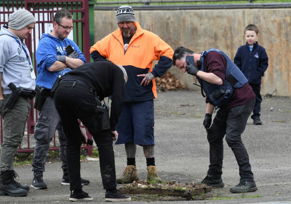 Opening in the case: Plain-clothes police officers searching the drains of Soldiers Hill last Friday for Ballarat man Nicholas Lee. Picture: Lachlan Bence