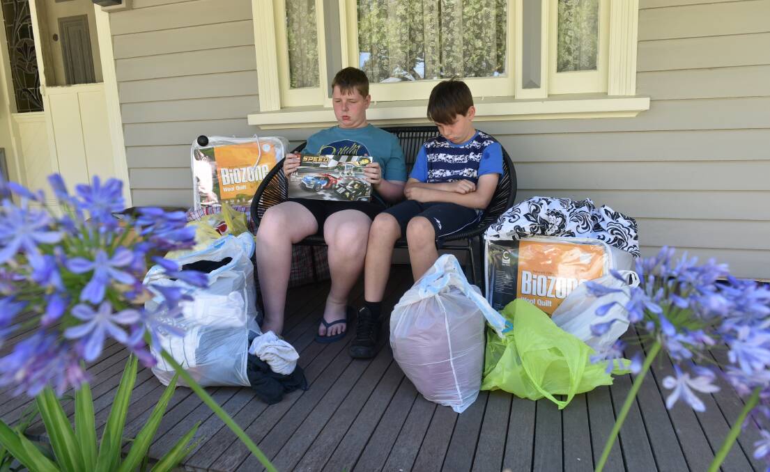 GRATEFUL: Riley and Kade Magner with some items donated to them, their mother Shona and grandparents Janine and Peter Huntly after a house fire. Picture: Jeremy Bannister