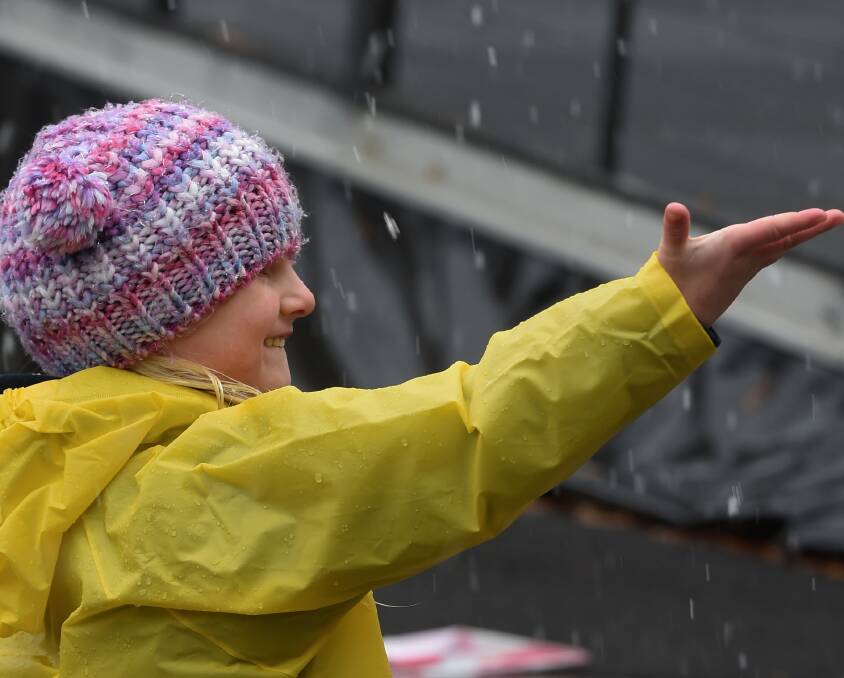 Winter wonderland: Alana Banks, 4, lets snowflakes melt upon her palm. Temperatures in Ballarat hovered around 2°C on Friday, but are expected to rise to 10°C Saturday. Pictures: Lachlan Bence