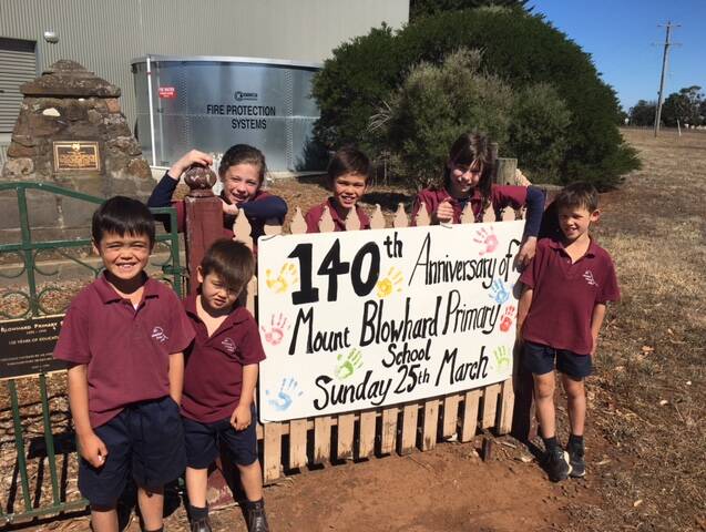 SMILES ALL AROUND: Mount Blowhard pupils are excited to celebrate a historic day for their school.