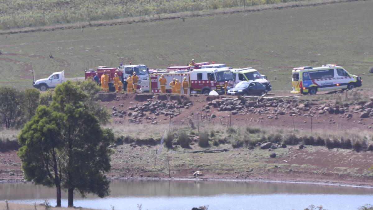 RESCUE: Emergency service workers suurounded the dam on Bill Fraser's property in the aftermath of the incident. Picture: Lachlan Bence.