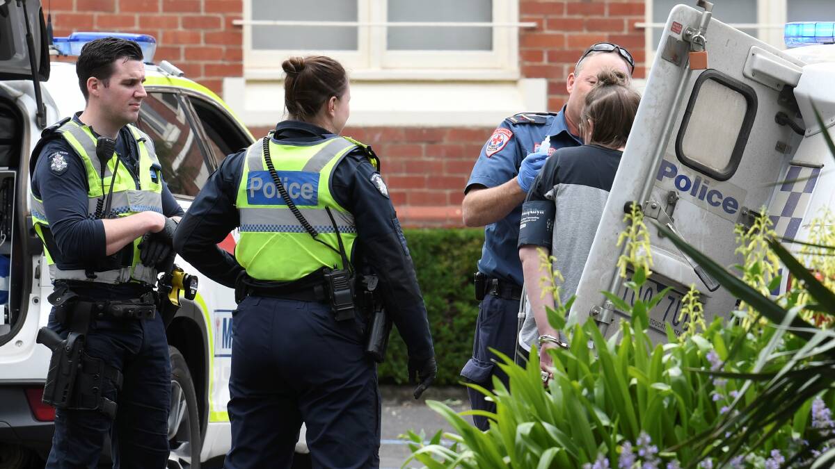 Police perform a swift arrest following a car theft and subsequent car fire. Picture: Lachlan Bence.