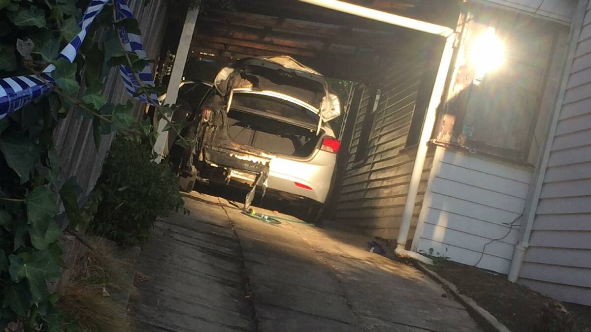 CLOSE CALL: A car has been set alight up a long driveway, underneath a car port.
