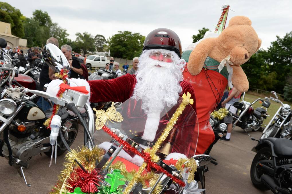SANTA: Ulysses Club Inc member Terry Howell gets into the festive spirit during Saturday's Motorcycle Toy Run charity event. Picture: Kate Healy.