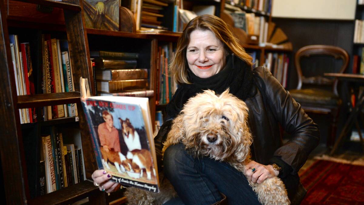 PAGE TURNER : The Known World owner Michelle Coxall and and her dog Brian are excited to reopen the store in Ballarat. Picture: Kate Healy.