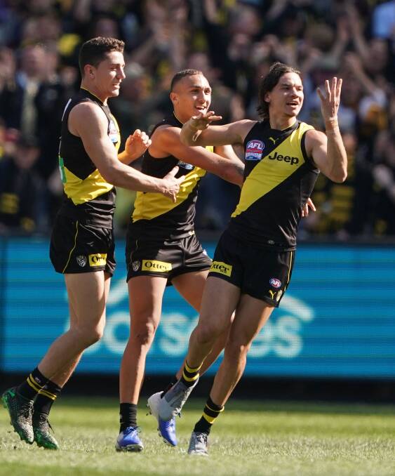PARTY TIME: Daniel Rioli of the Tigers is congratulated by his teammates after kicking a goal during the 2019 AFL Grand Final. Picture: Scott Barbour