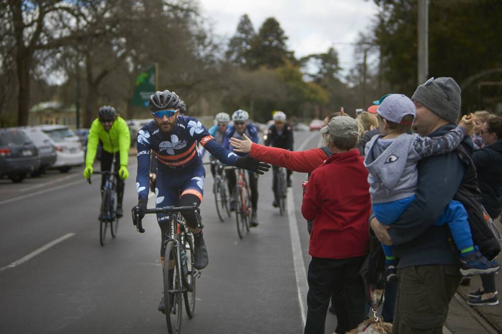 Nick Locandro (front) gives a high five to one of his many supporters at Lake Wendouree as he and his team arrive back after their 14-day journey from Uluru. Picture: Luka Kauzlaric