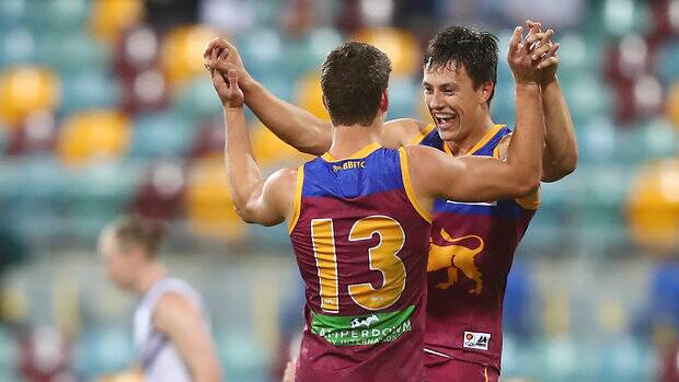 WINNERS ARE GRINNERS: Jarrod and Hugh celebrate their first win against Fremantle in 2017. Picture: Brisbane Lions.
