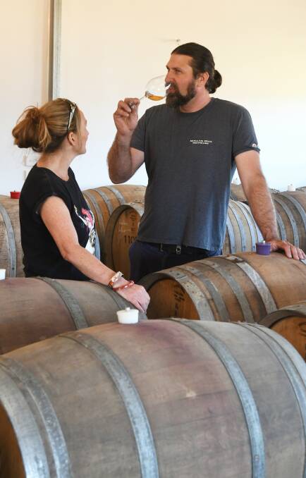 TAKE A SIP: Ed Nolle samples some of his barrel fermented cider with his wife Fiona. Picture: Lachlan Bence.