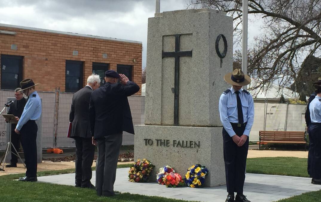SALUTE: RAAFA Bendigo President Roy Gaffee salutes the Sebastopol War Memorial alongside RAAFA Ballarat President Tom Roberts.