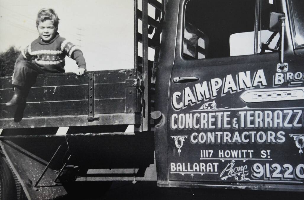 Simon Campana sitting in the family's business ute. 1960s