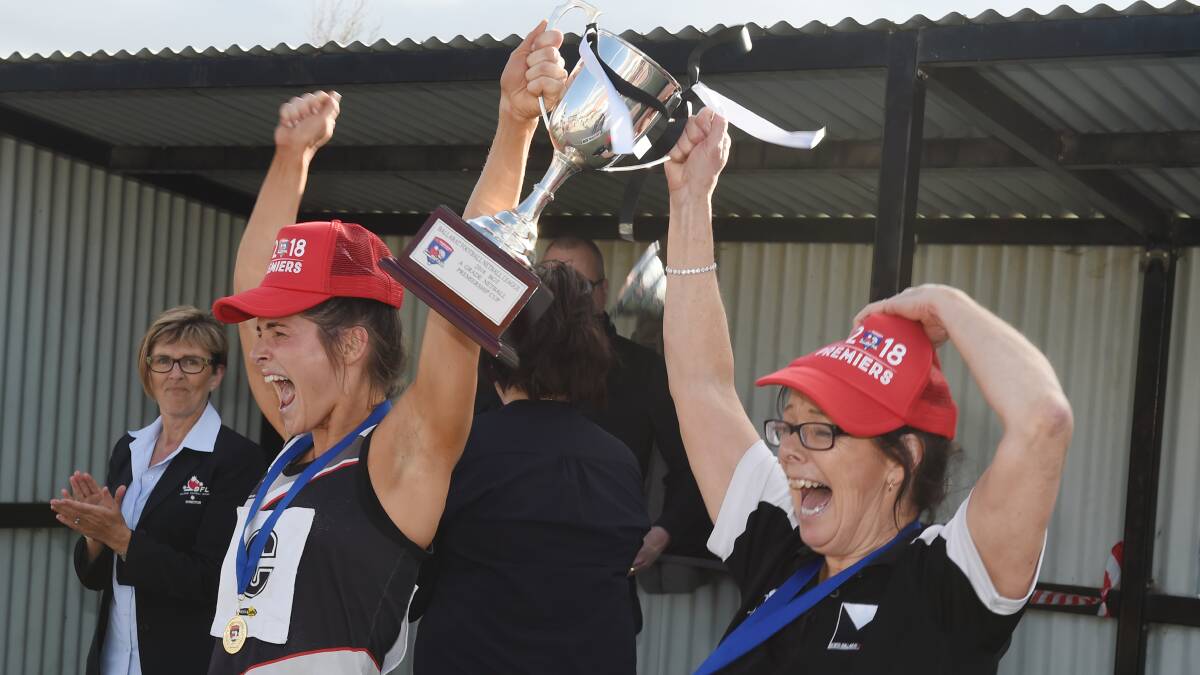 Stacey McCartin and Annie McCartin celebrate their premiership win. Picture: Kate Healy.