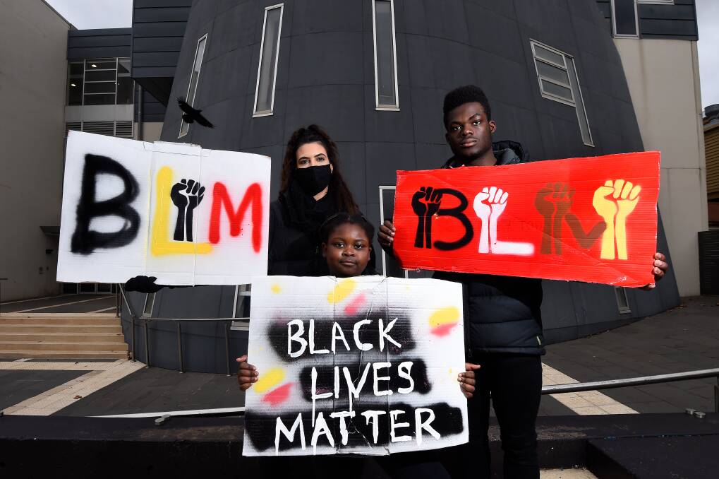 TOGETHER: Chloe Saunders, Eliora and Lunorphare Kodjo Folly display posters made for the Ballaarat Allies group silent Black Lives Matter protest. Picture: Adam Trafford.
