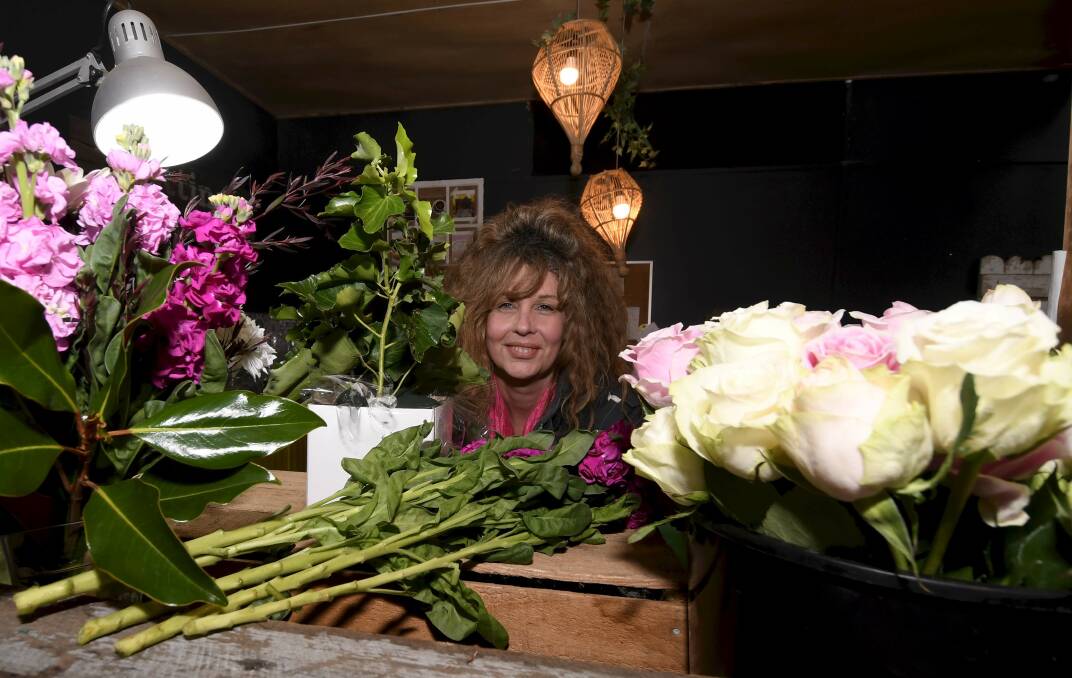 FLOWER POWER: Jodie Absolum from Whites Florist prepares for the busiest day of the year. Picture: Lachlan Bence.