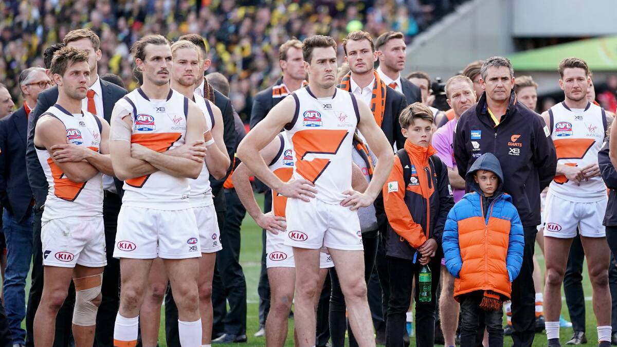 DEFLATED: Jeremy Cameron stands with his GWS teammates following its 89-point loss to Richmond in the AFL grand final. Picture: Scott Barbour.