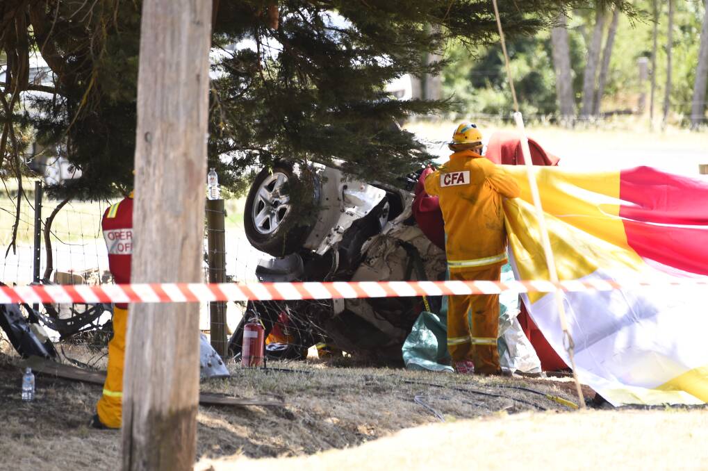 TRAUMA: CFA members helping cover the carnage after the December collision. 