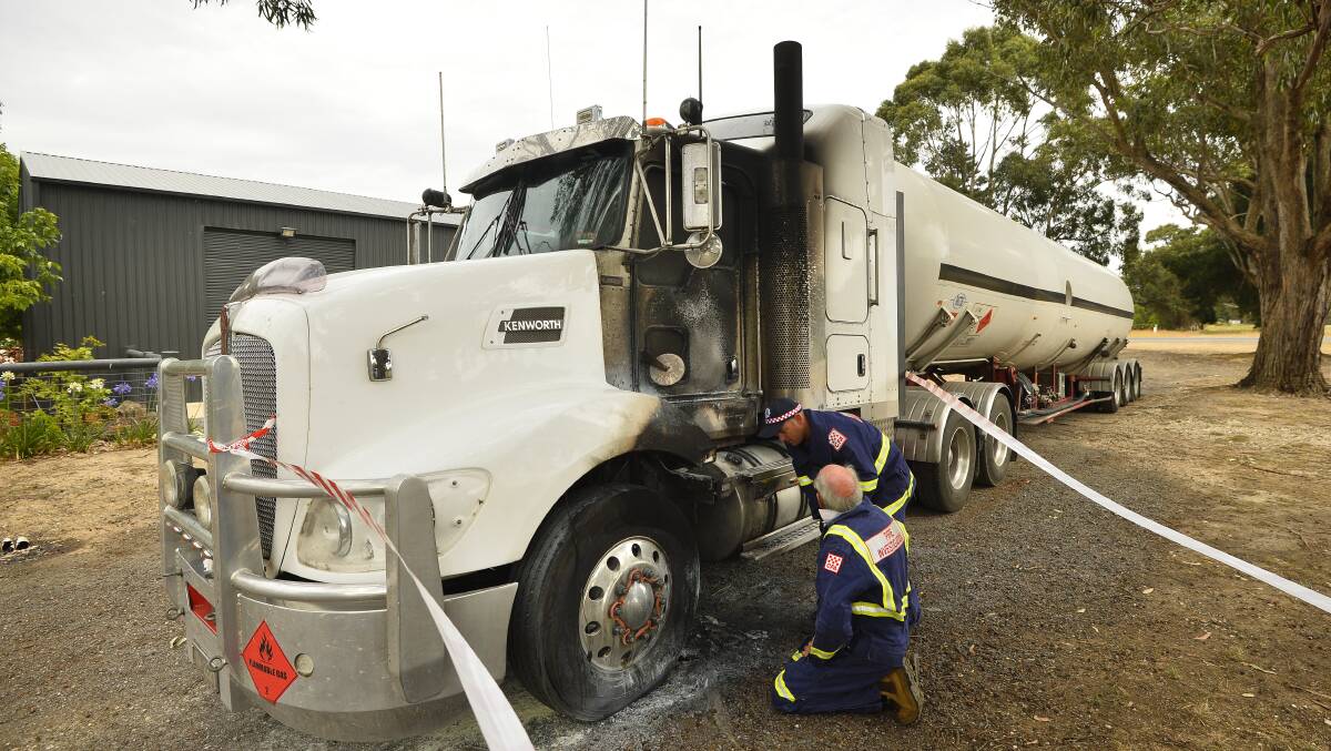 Fire investigators inspect the truck fire in Creswick North. Picture: Dylan Burns