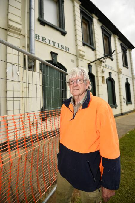 Fenced off: Creswick Ward councillor Don Henderson inspecting the state of the British Hotel on Albert Street, which was hit with a building. Picture: Dylan Burns 
