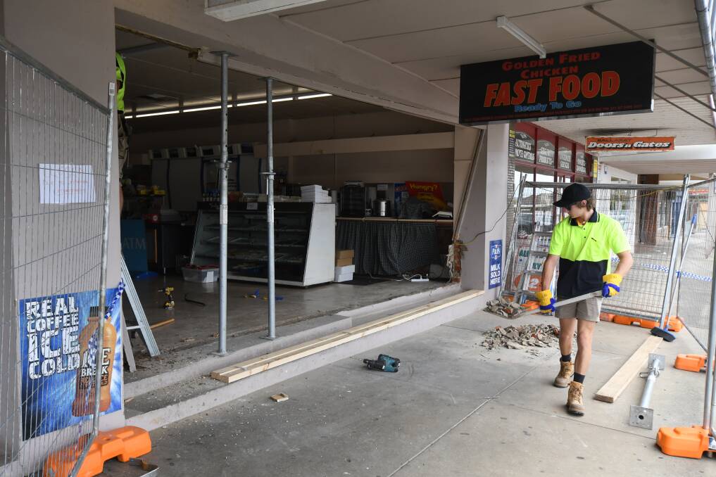 Tradies work on a Harold Street shopfront which was hit in a ram raid on New Years Day. Picture: Lachlan Bence 