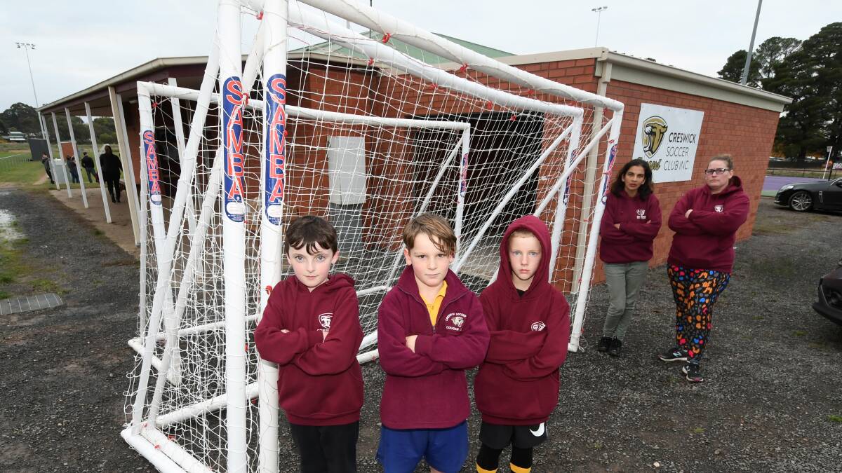 No ball, no play: Creswick Cougars Soccer Club players Declan O'Kelly, 9, Walker Knowles, 7, and Owen Johnston, 9, with Chantel Leaver and Raylene Knowles out the front of their club rooms which were broken into on Monday night. Picture: Lachlan Bence 