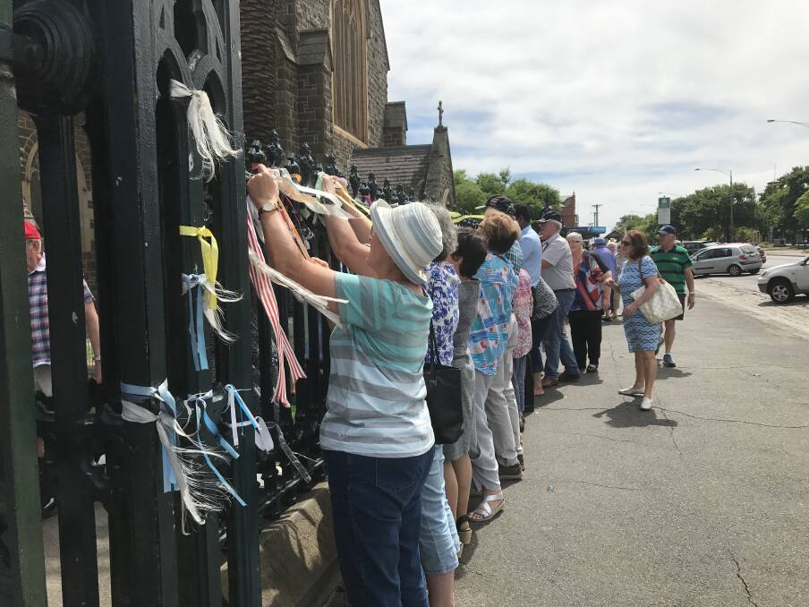 Parishioners removing ribbons at St Patrick's Cathedral on Sunday. 