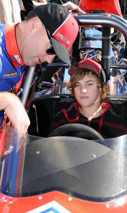 Fast machine: Matt Forbes shows off his championship winning dragster to 16-year-old Ballarat Specialist School student Kyle Gallagher on Tuesday.  Picture: Kate Healy.