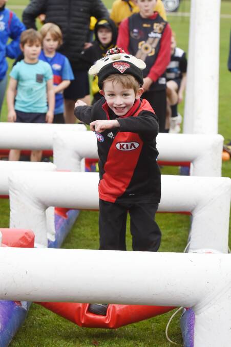 Getting involved:  Ballarat's Hayden Winzar, 5, was right among the action at Ballarat Grammar School on Sunday for the Access All Abilities Sports Auskick clinic with the Western Bulldogs.  Picture: Kate Healy.  