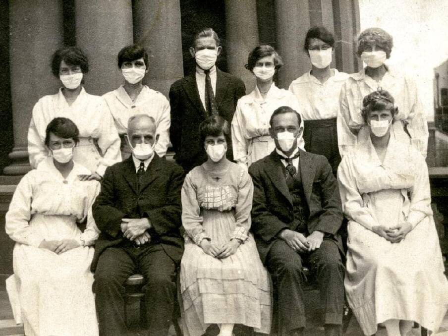 Masks were a limited option: Sitting on the steps of the Sydney Town Hall in 1919. Picture:City of Sydney Archive.