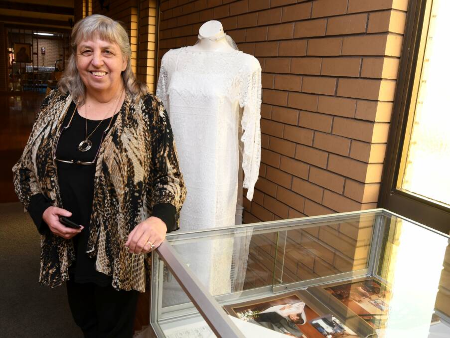 Displays: Margaret Neale of St Matthew's in front of a display in the church. The wedding dress behind her is her own. Picture: Lachlan Bence.