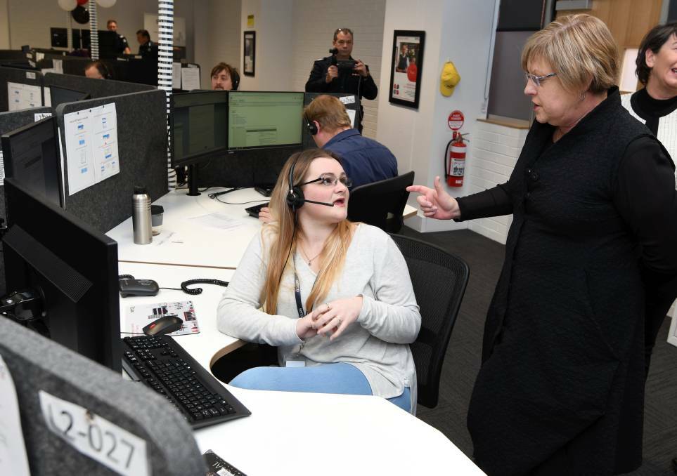 LAUNCH: Call taker Kayla Gates with Police and Emergency Services Minister Lisa Neville at the opening of the Serco centre in July this year. Picture: Lachlan Bence.