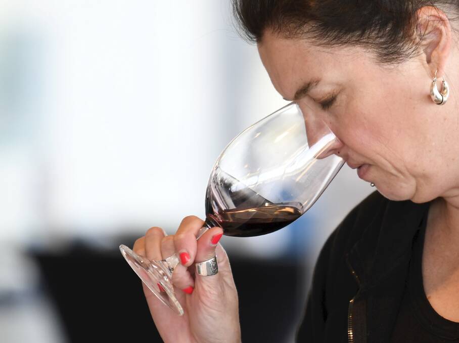 Aroma and notes: Natasha Webster tests a regional red at the Ballarat Wine Show. Picture: Lachlan Bence.