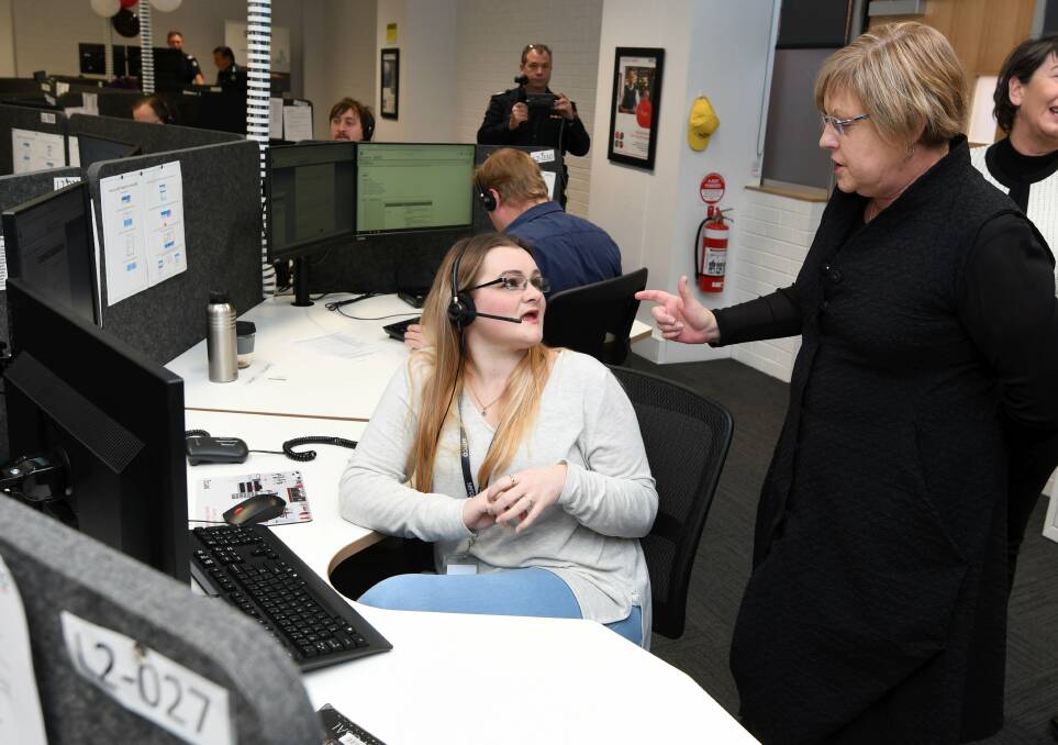 LAUNCH: Call taker Kayla Gates with Police and Emergency Services Minister Lisa Neville at the opening of the Serco centre in July this year. Picture: Lachlan Bence
