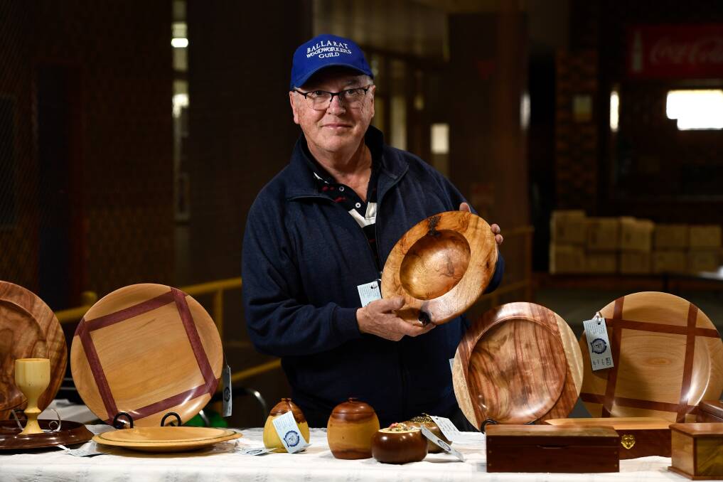 On the turn: Woodworkers Guild president Ross Holst with some of his bowls on display this weekend at the annual Wood & Craft Show, held at the Wendouree Sport and Events Centre. Pictures: Adam Trafford.