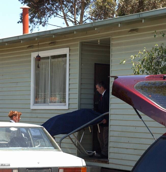 The beginning of a long process: undertakers remove a body from a house in Ballarat. Picture: Jeremy Bannister.