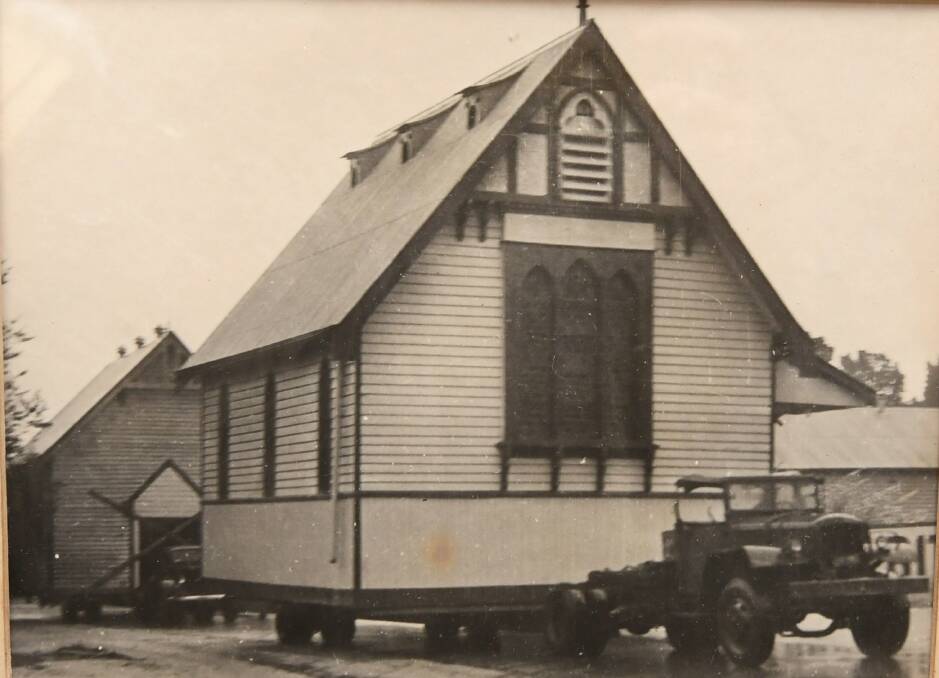 On the move: the original church and church hall on the move sometime in the 1940s or 1950s. Both have been demolished or moved from the present site.