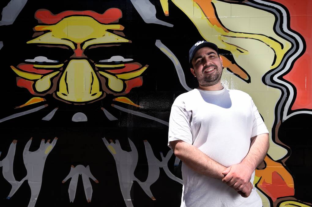Street artist at heart: Josh Muir with his mural 'Roots' which is located in Alfred Deakin Place, Ballarat. Mr Muir died on Saturday, February 5, 2022.