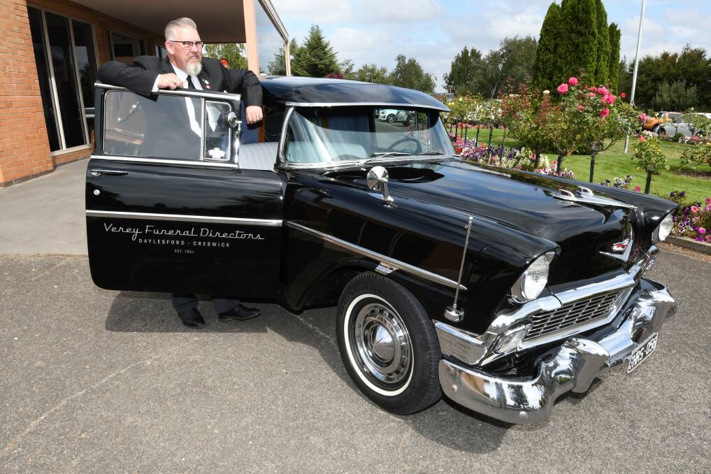 A fine ride: Andrew Nuske of Creswick's Verey Funeral Directors with his 1956 Chevrolet hearse, which is a popular choice for the last ride. Picture: Lachlan Bence.