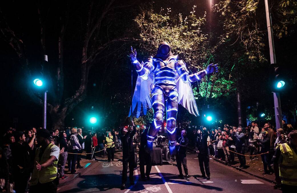 Messages of hope: The White Knight Messenger can soar six metres above the street to deliver messages of peace and compassion. It's operated by eight puppeteers. Picture: Jason Lau.