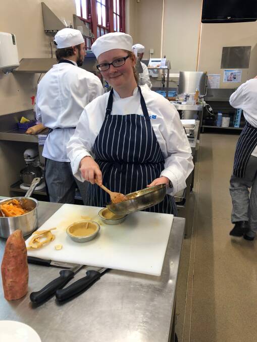 Getting a lid on it: An apprentice at Fed Uni pops in her pie filling for the competition, which gives them a chance to compete against our best. Picture: Kate Davis.