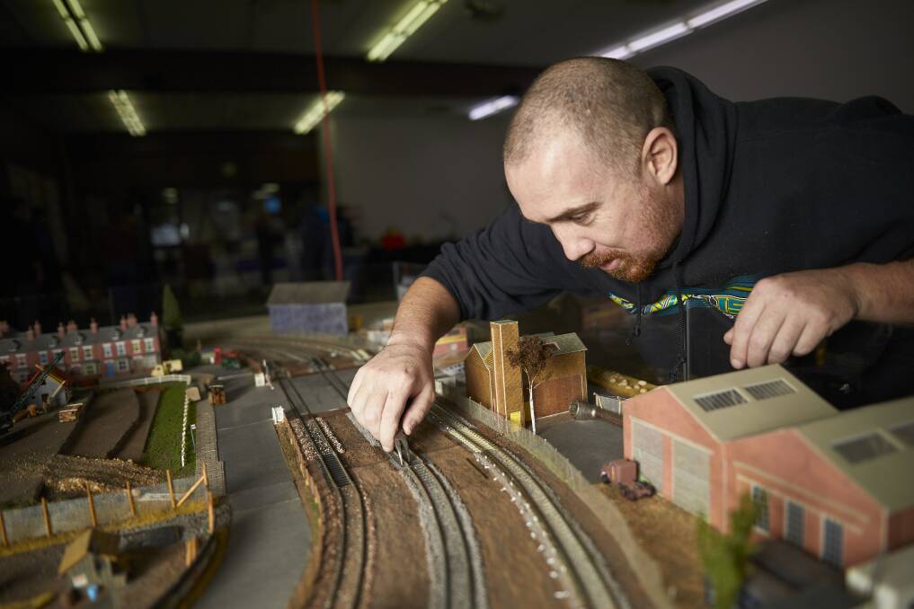 Paul Barnard of Drysdale lays some track for the exhibition. Picture: Luka Kauzlaric.