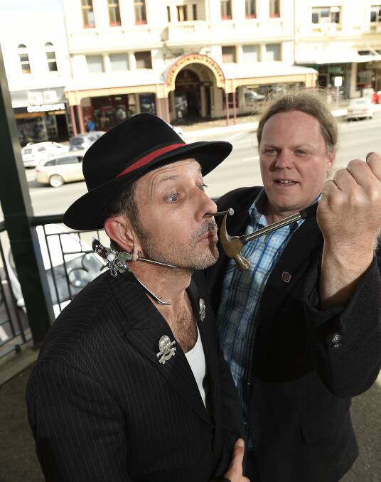 Nail-biting: World Sideshow Festival director Shep Huntly (with friend Rex Hardware) demonstrating the art of nail-pulling in 2015. Picture: Lachlan Bence.